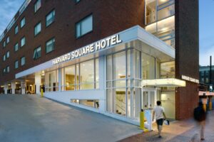 Harvard Square Hotel entrance on a city street at dusk